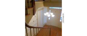 Entryway with wooden staircase, wood floors, and chandelier