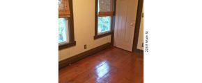 Room with hardwood floors, closet, and large windows