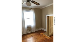 Room with steps up into it, ceiling fan, hardwood floors and window