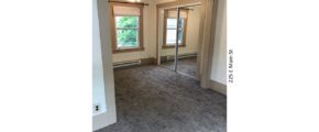 Bedroom with carpet, ceiling fan with a light, closet with mirror doors, and window