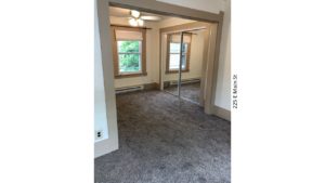 Bedroom with carpet, ceiling fan with a light, closet with mirror doors, and window