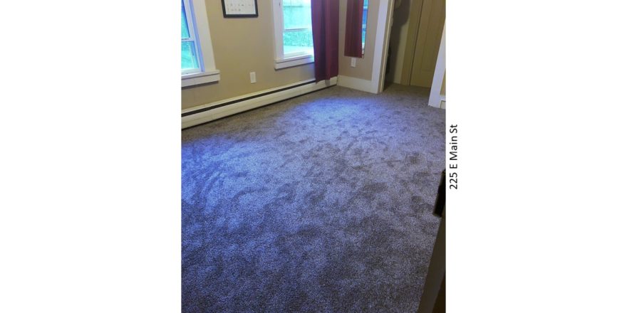 Unfurnished, carpeted bedroom with closet