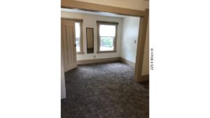 Unfurnished, carpeted bedroom with two windows