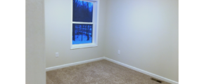 Unfurnished bedroom with tan carpet.