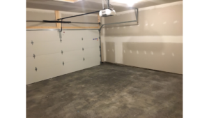 Empty garage with large door and cement floor