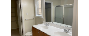 a bathroom with two sinks and a toilet