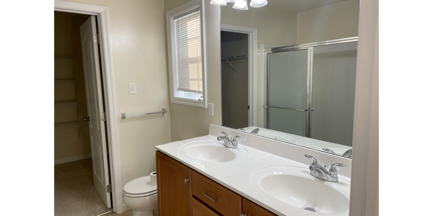 a bathroom with two sinks and a toilet