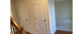 three white doors in a room with hardwood floors