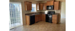 a kitchen with black appliances and wooden cabinets