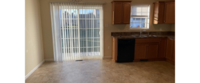 an empty kitchen and dining room in a house