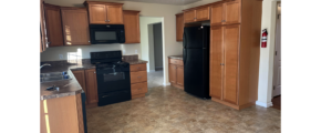 a kitchen with black appliances and wooden cabinets