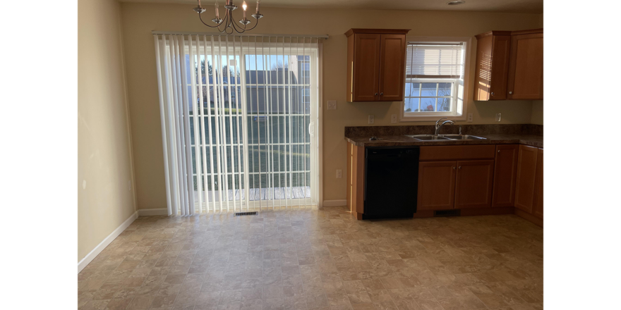 an empty kitchen and dining room in a house