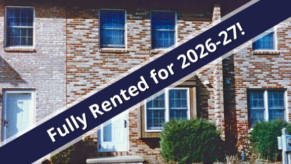 a house for sale with a blue ribbon in front of it