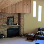 a living room filled with furniture and a flat screen tv and fireplace