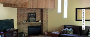 a living room filled with furniture and a flat screen tv and fireplace