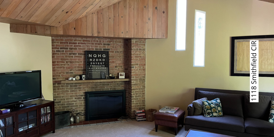 a living room filled with furniture and a flat screen tv and fireplace