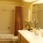 Bathroom with shower/tub combo, toilet, and vanity.