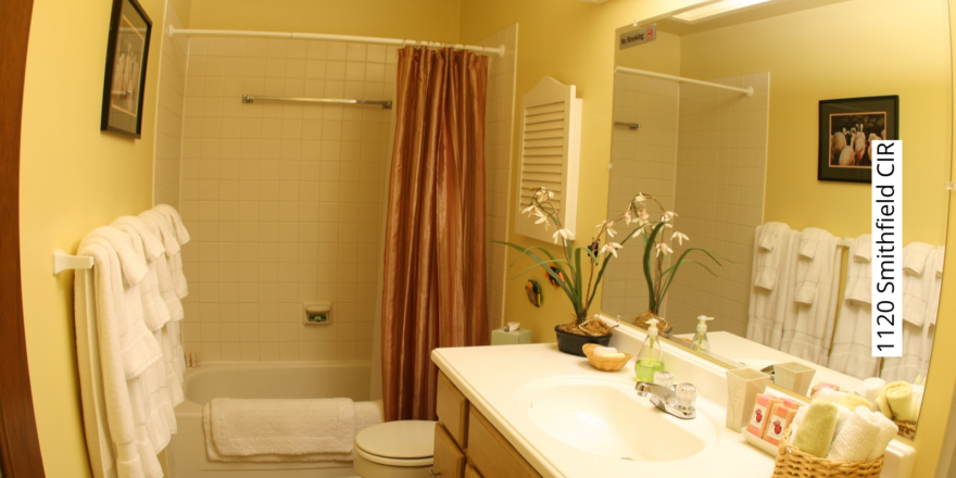 Bathroom with shower/tub combo, toilet, and vanity.