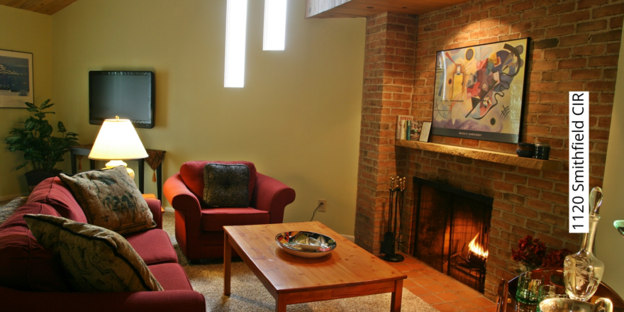 a living room filled with furniture and a fire place