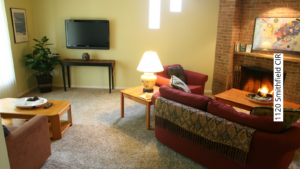 a living room filled with furniture and a fire place