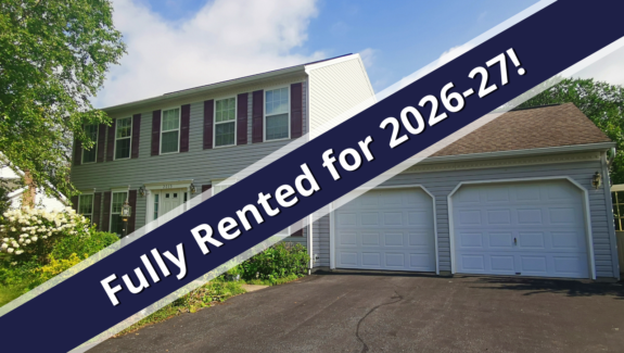 a house for sale with a for sale sign in front of it