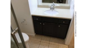 Bathroom with vanity, toilet, and mirror