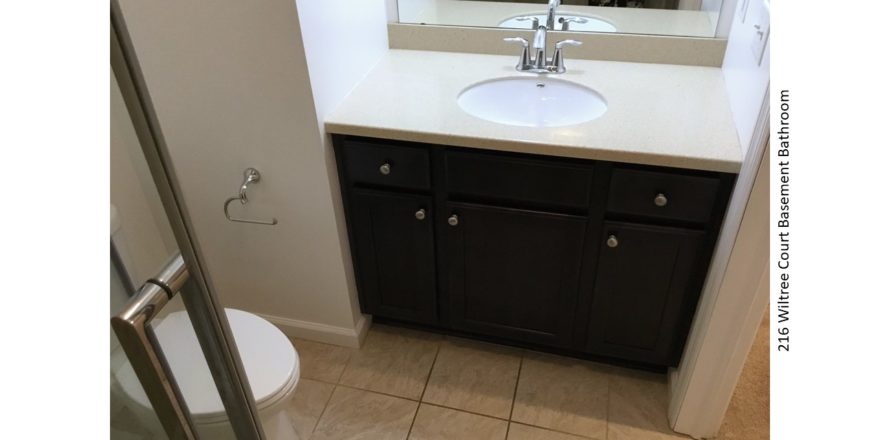 Bathroom with vanity, toilet, and mirror