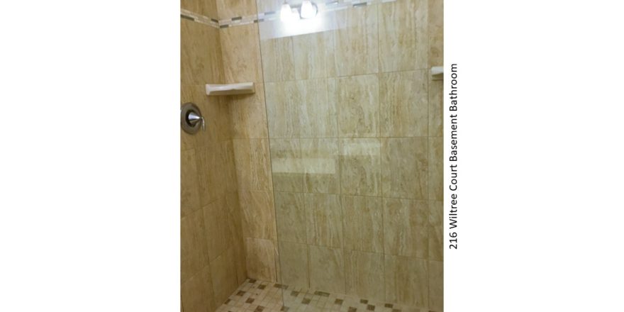 Shower stall with tile and sliding glass door