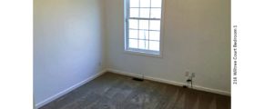 Unfurnished, carpeted bedroom with window