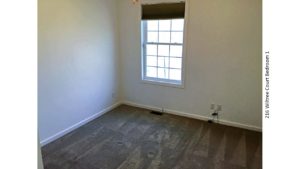 Unfurnished, carpeted bedroom with window