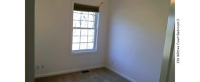 Unfurnished, carpeted bedroom with window and ceiling fan