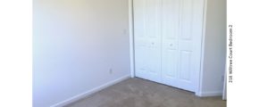 Unfurnished, carpeted bedroom with closet