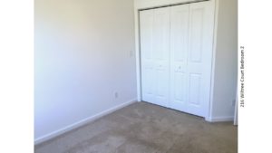 Unfurnished, carpeted bedroom with closet