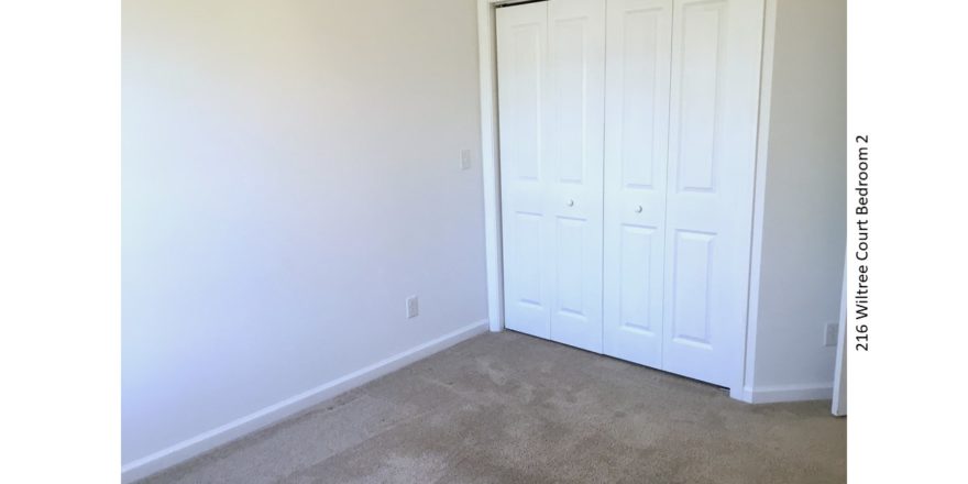 Unfurnished, carpeted bedroom with closet