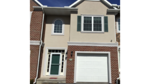 Exterior of townhouse with brick and stucco siding