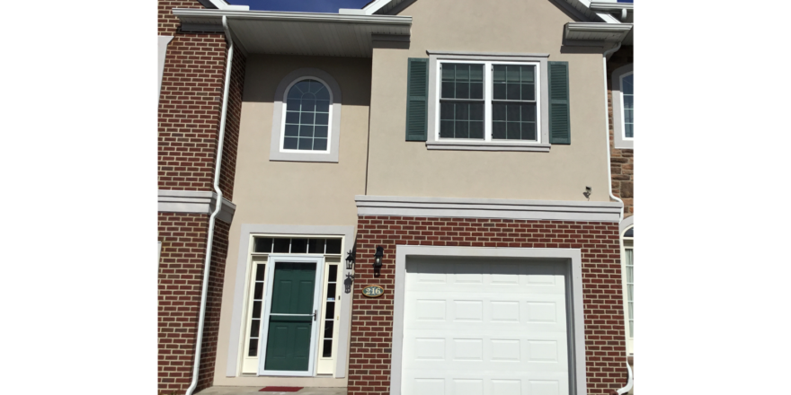 Exterior of townhouse with brick and stucco siding