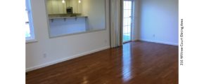 Dining area with hardwood floors, large mirror, and sliding glass door