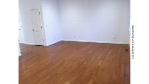 Living area with hardwood floors and window