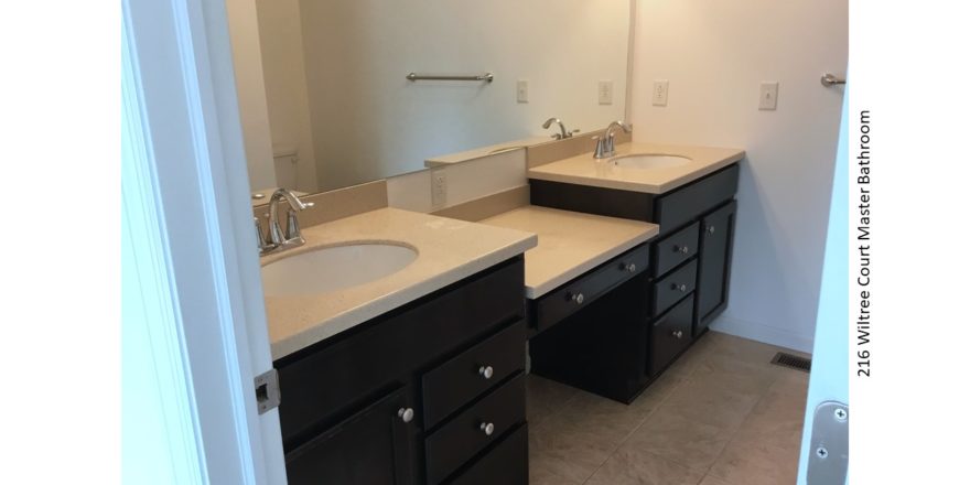 Bathroom with double sink vanity and large mirror