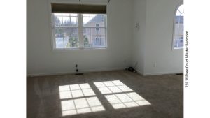 Unfurnished, carpeted bedroom with windows