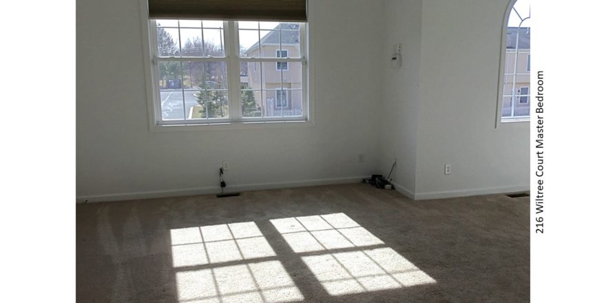 Unfurnished, carpeted bedroom with windows