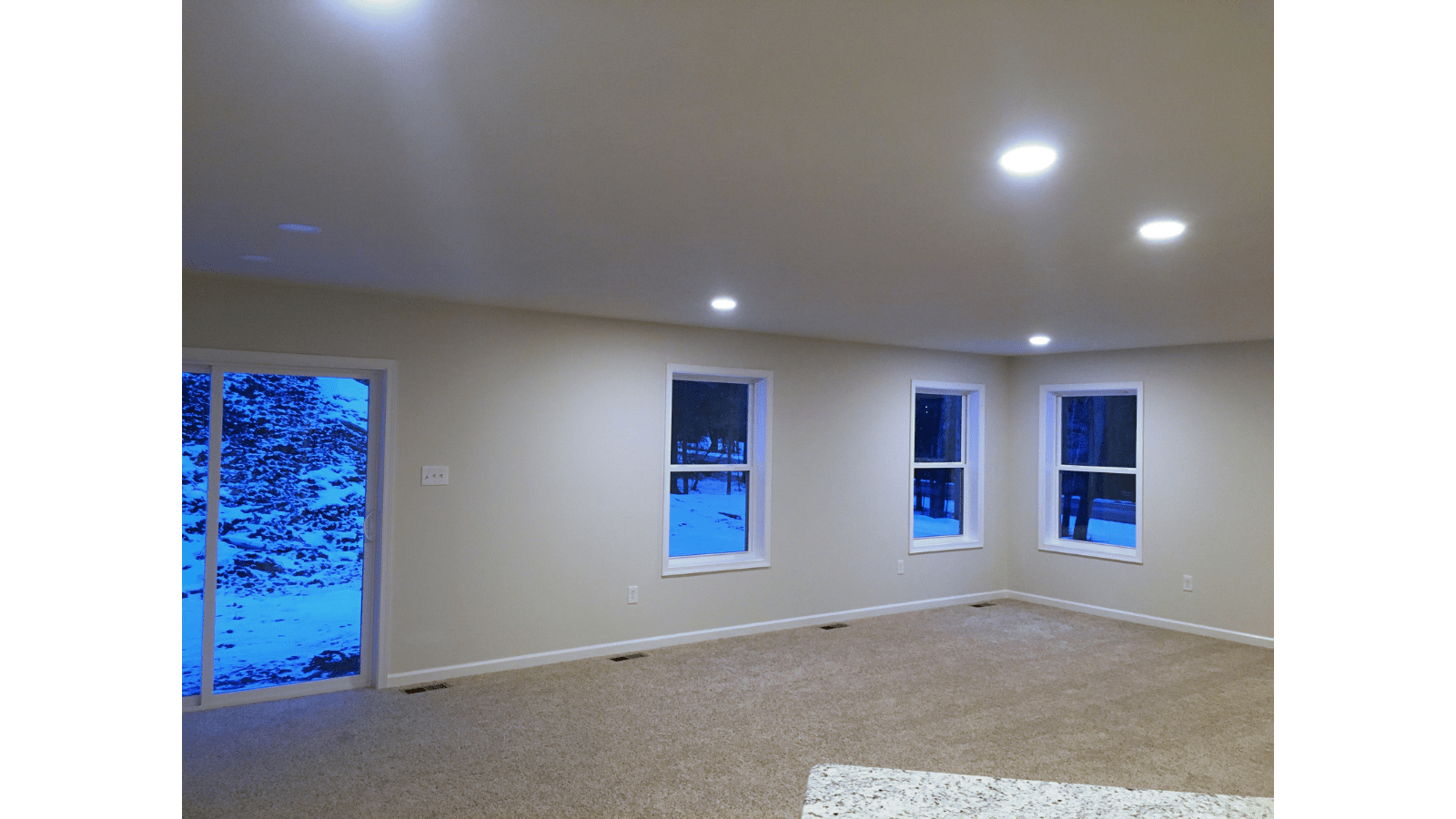 Living room with sliding glass door and windows