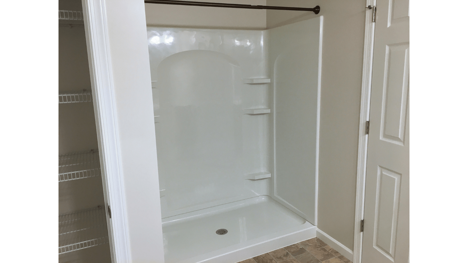 White shower stall with shelves