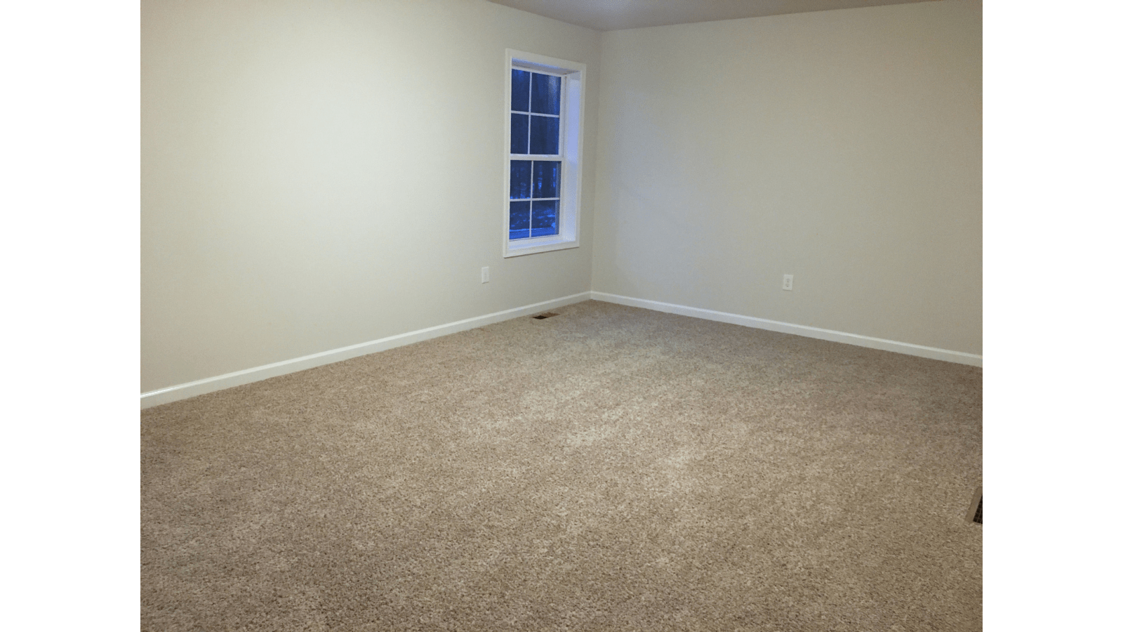 Empty room with beige carpet and window