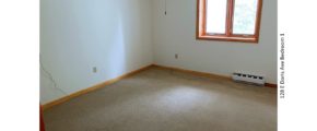 Unfurnished, carpeted bedroom with crank windows and ceiling fan with light