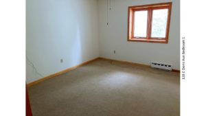 Unfurnished, carpeted bedroom with crank windows and ceiling fan with light