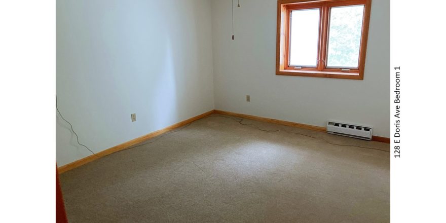 Unfurnished, carpeted bedroom with crank windows and ceiling fan with light
