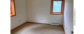 Unfurnished and carpeted bedroom with crank windows