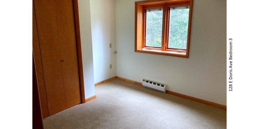 Unfurnished and carpeted bedroom with closet and crank windows