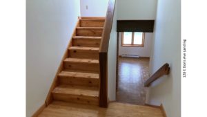 Stair landing with wood stairs and railings